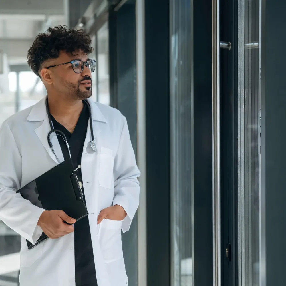 Doctor is indoors in the modern building.